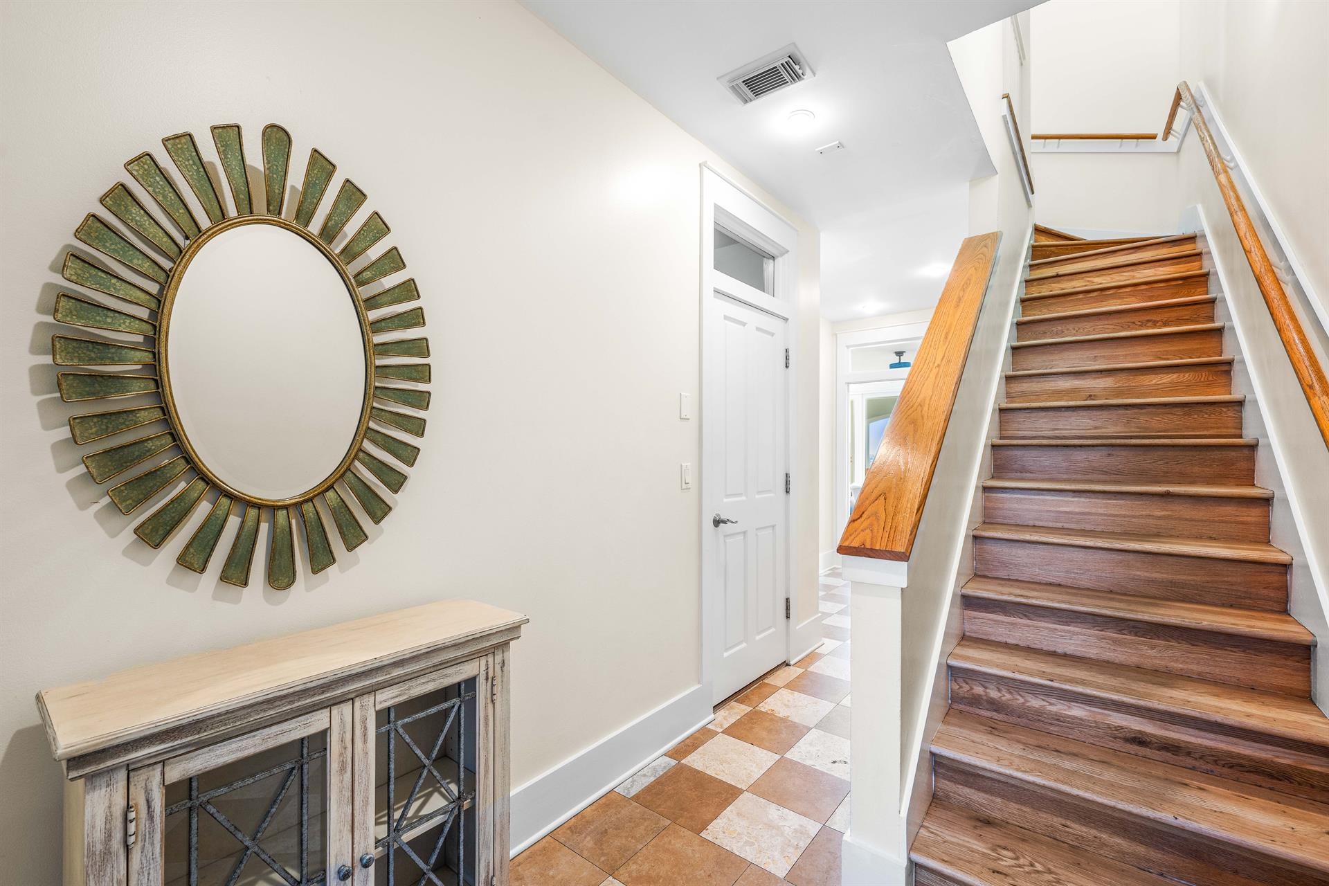 1st Floor Foyer with Whimsical Checkerboard Travertine Tile Flooring.   Use the stairs or elevator to access the upper floors.