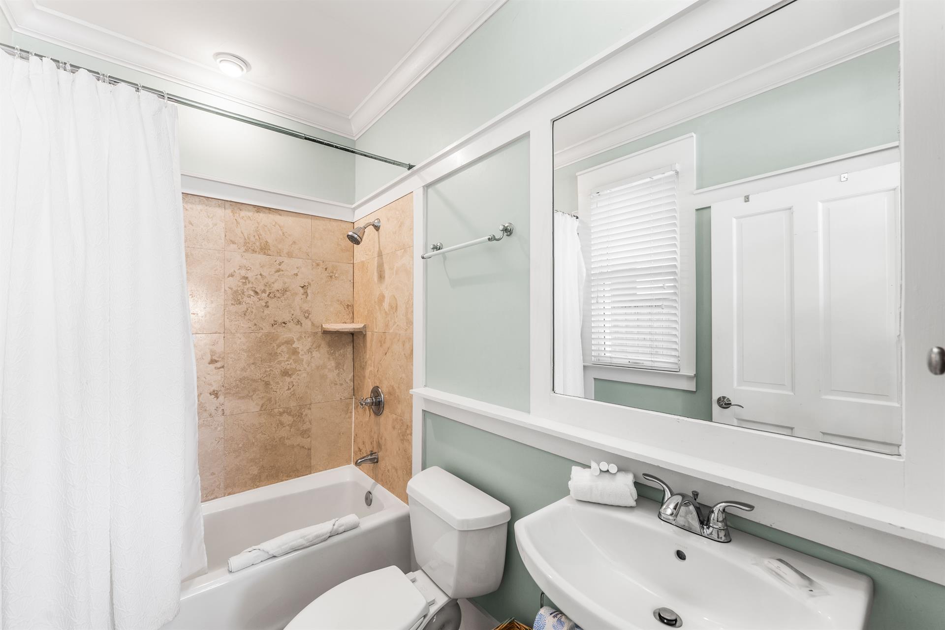 1st floor ensuite bathroom with a bathtubshower combination.