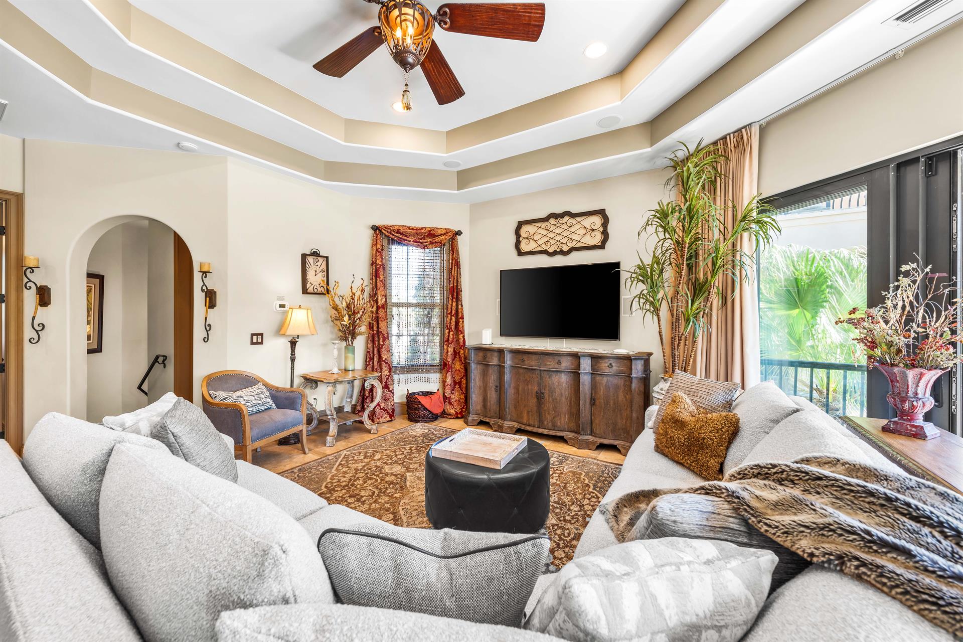 Living area with double tray ceiling  an oversized  70 smart tv