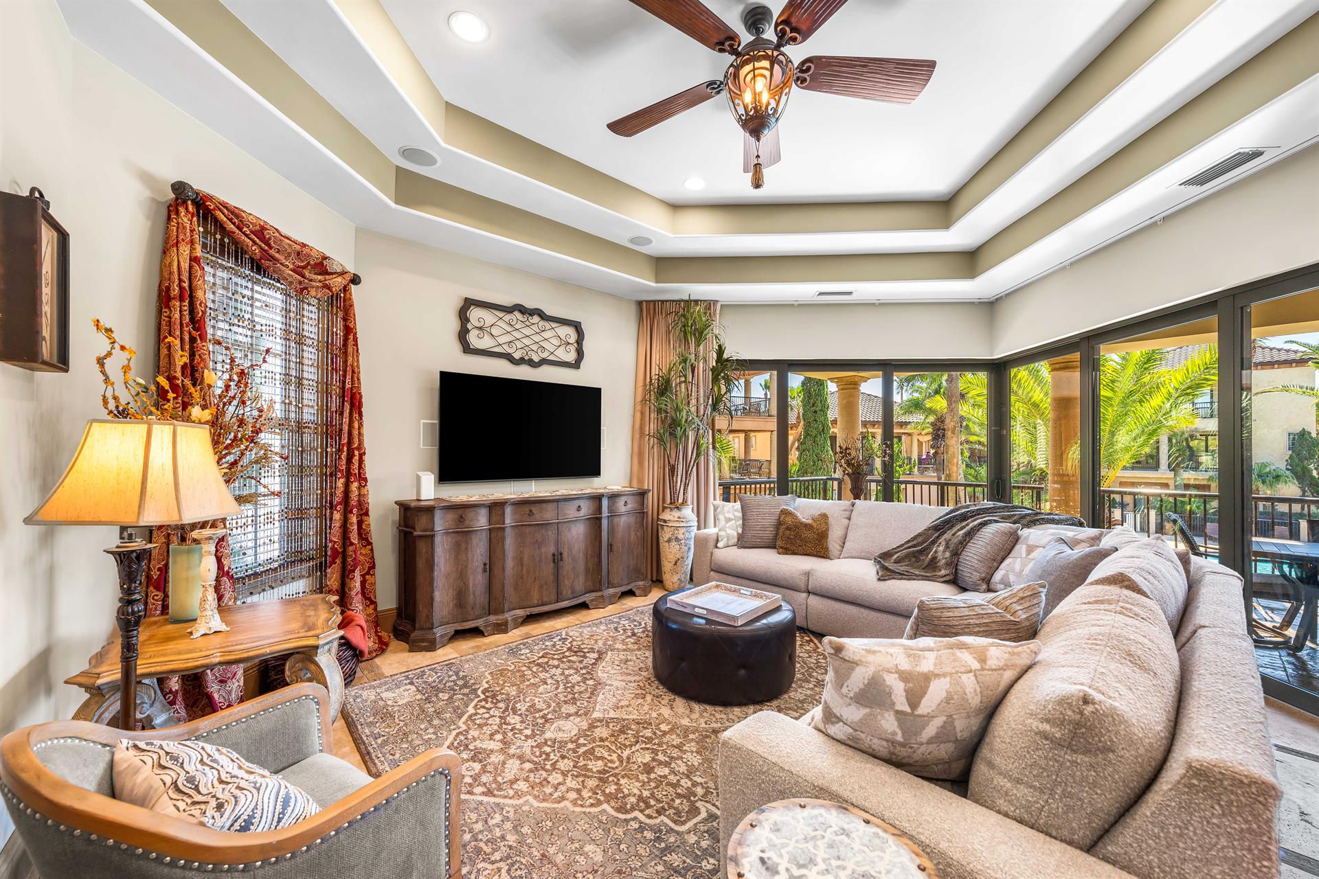 The sophisticated furnishings include a large curved sectional sofa