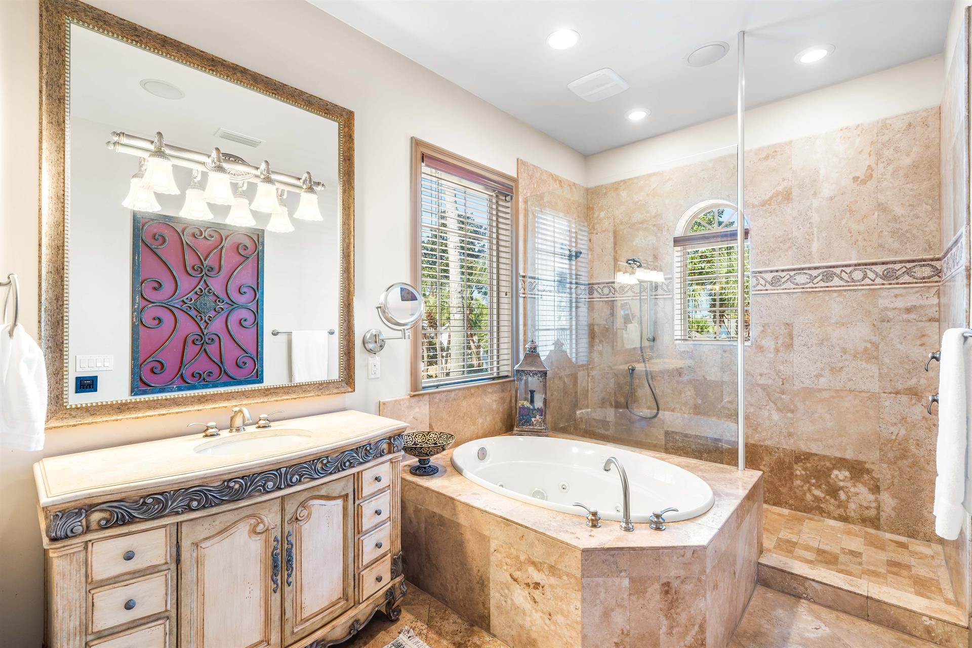 Distinctive vanity, walkin frameless shower, whirlpool bathtub,  separate water closet in this primary bathroom.