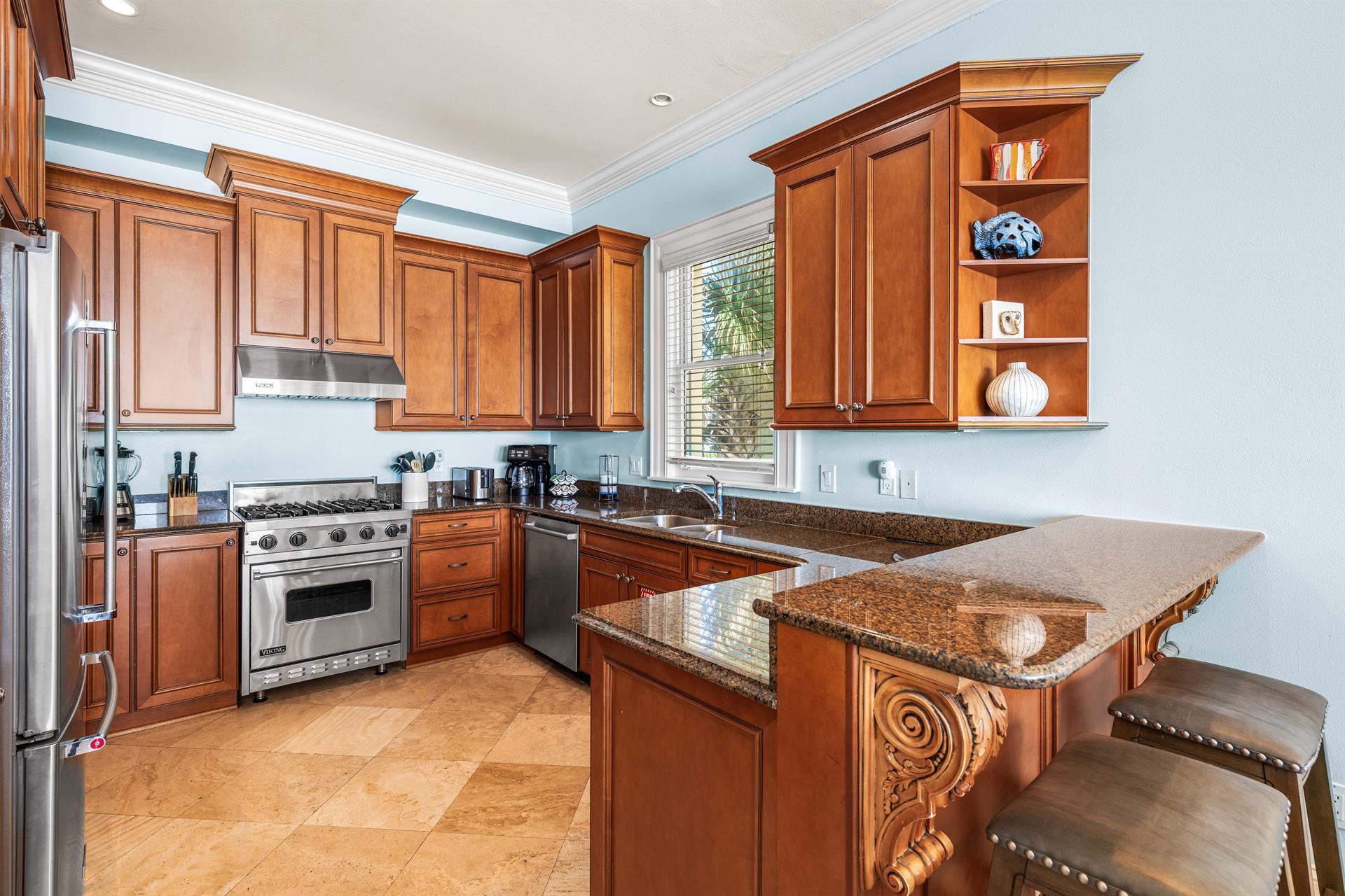 Second Floor Fully Stocked Kitchen with Granite Countertops, Stainless Steel Appliances including Viking Range, KitchenAid Refrigerator, and UnderCounter Ice Maker.