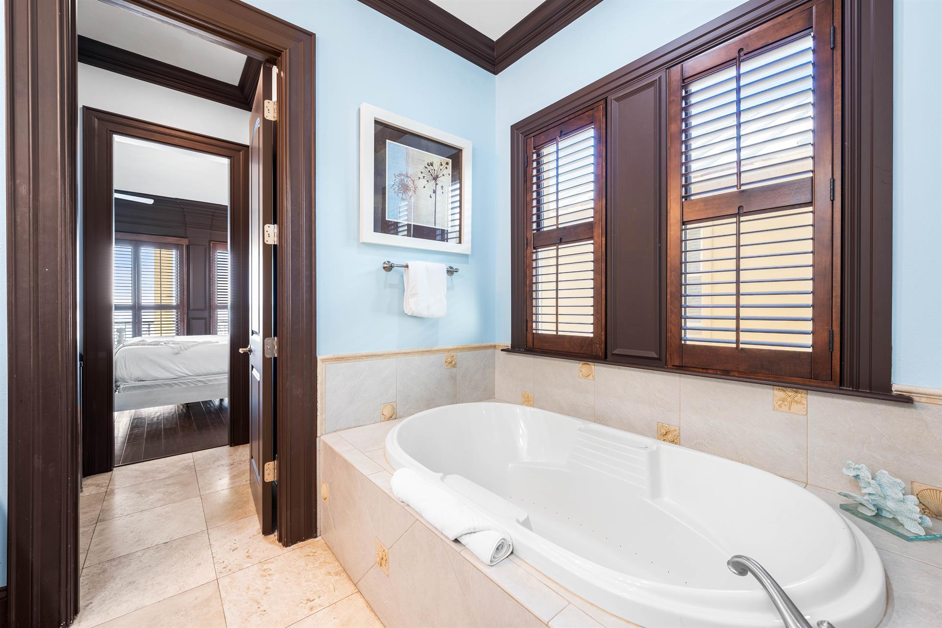 Large soaking bathtub in this primary ensuite.