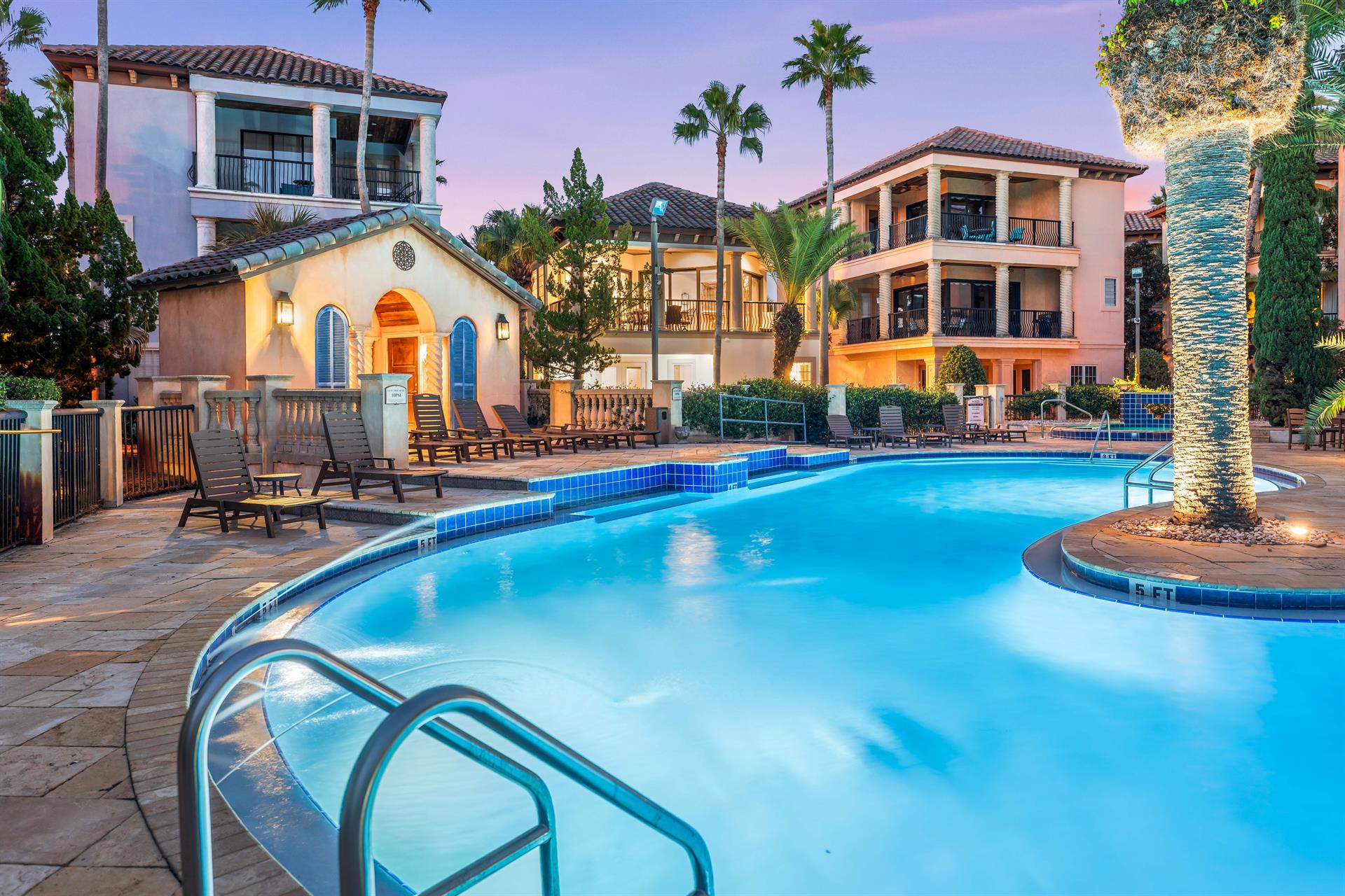 The lagoon style pool has a waterfall feature, outdoor shower, lounge chairs, dining tables, heated whirlpool spa, and outdoor bathrooms.  Stunning