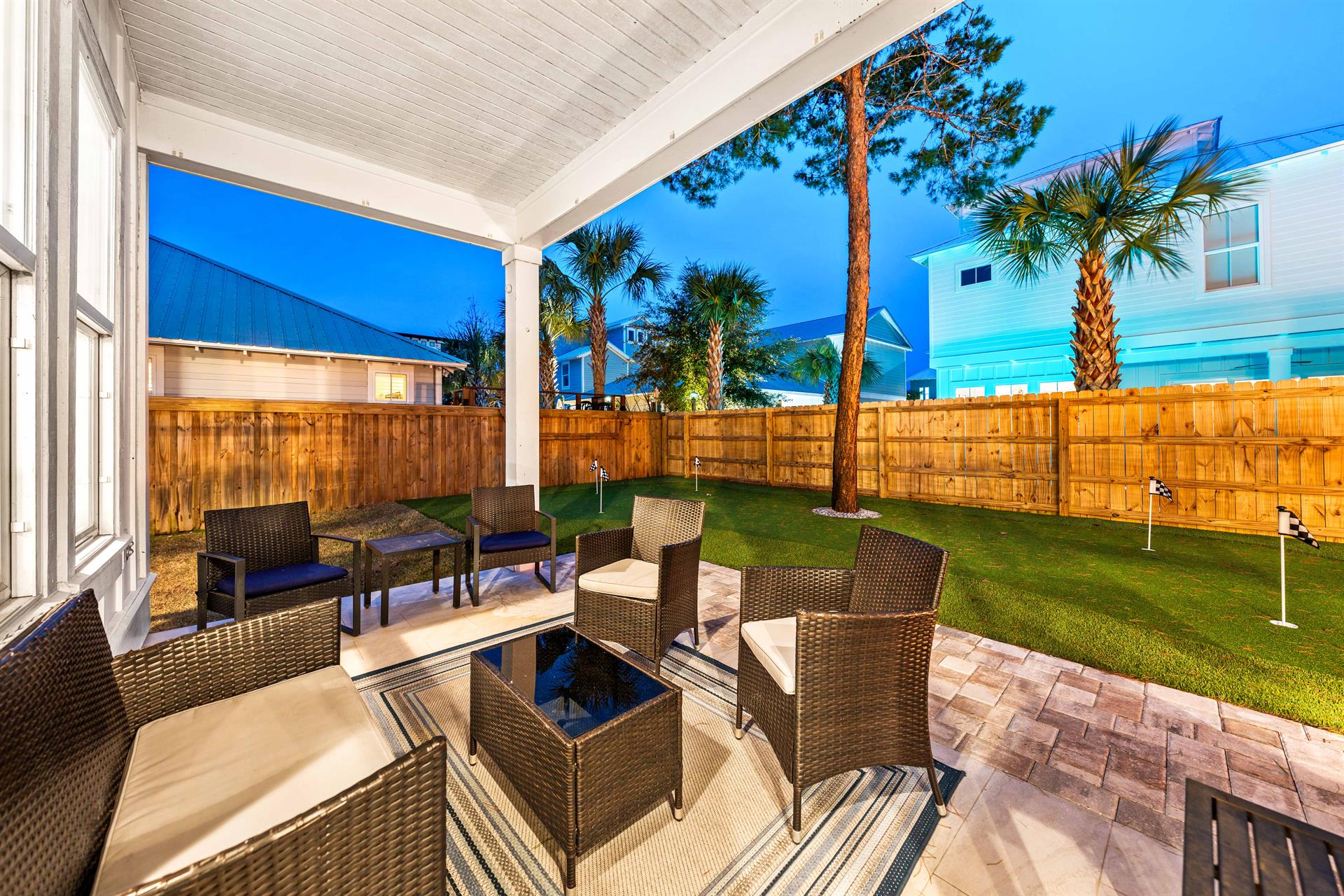 Outdoor space with 5 hole putting green and plenty of seating under the covered porch