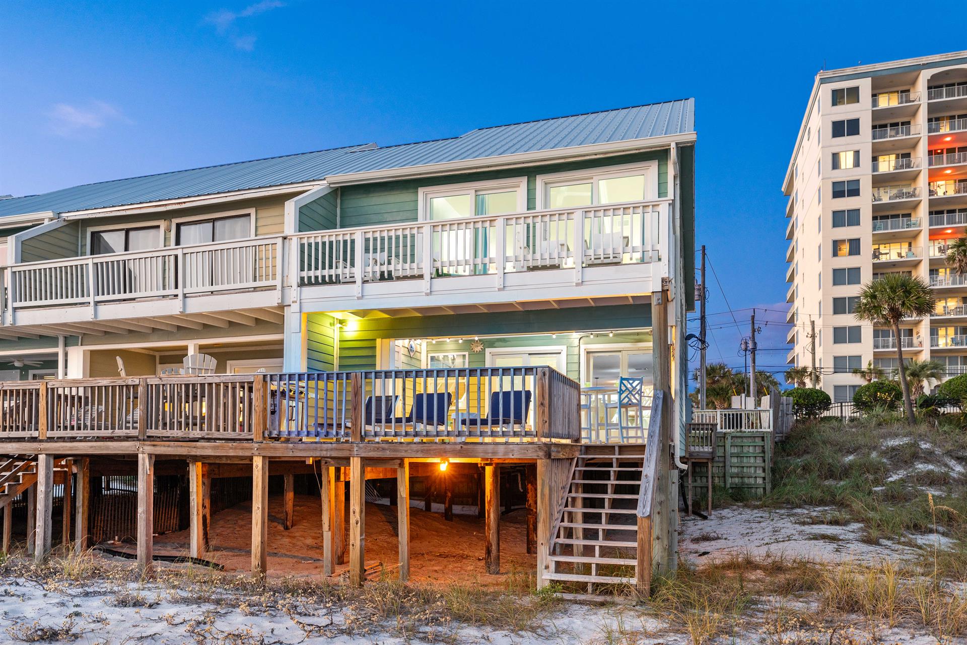 Step off the deck right into the sand and hit the beach.   Outdoor shower at the bottom of the steps for a quick rinse off