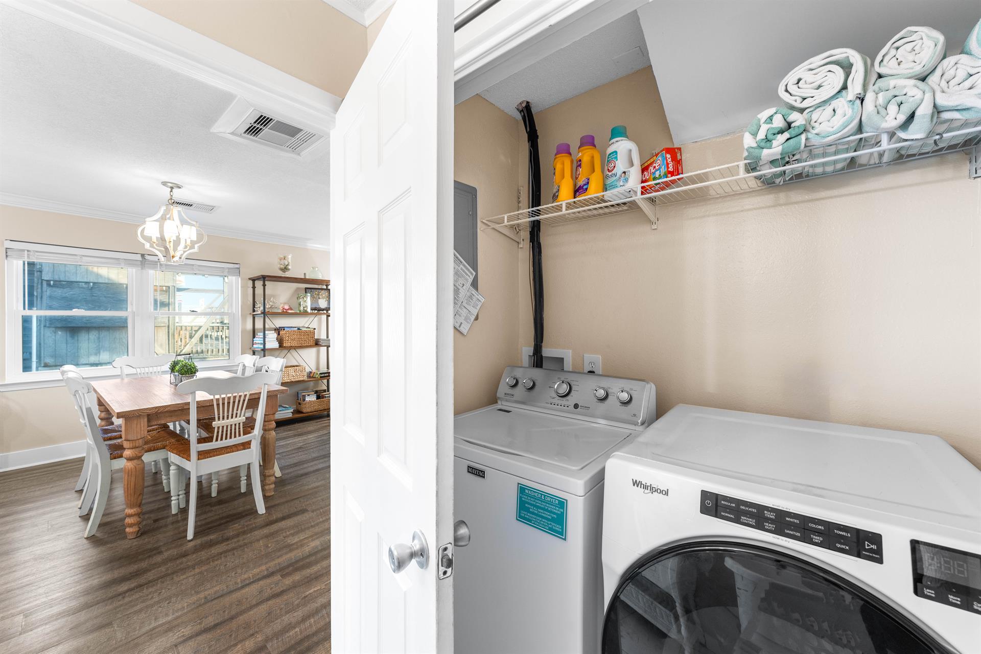 Washer and Dryer with laundry detergent and dryer sheets. Green and white beach towels for your use.