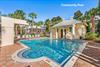 The Gated Community Pool with Waterfall Feature, Chaise Loungers for Sunning, DressingRestrooms,  Outdoor Shower  a minute walk from Toes in the Sand.