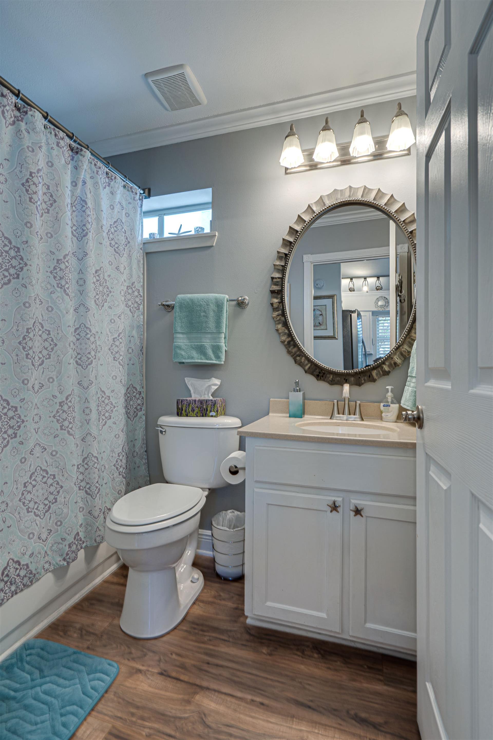 Full bathroom with bathtubshower combination adjacent to the king bedroom on the first floor