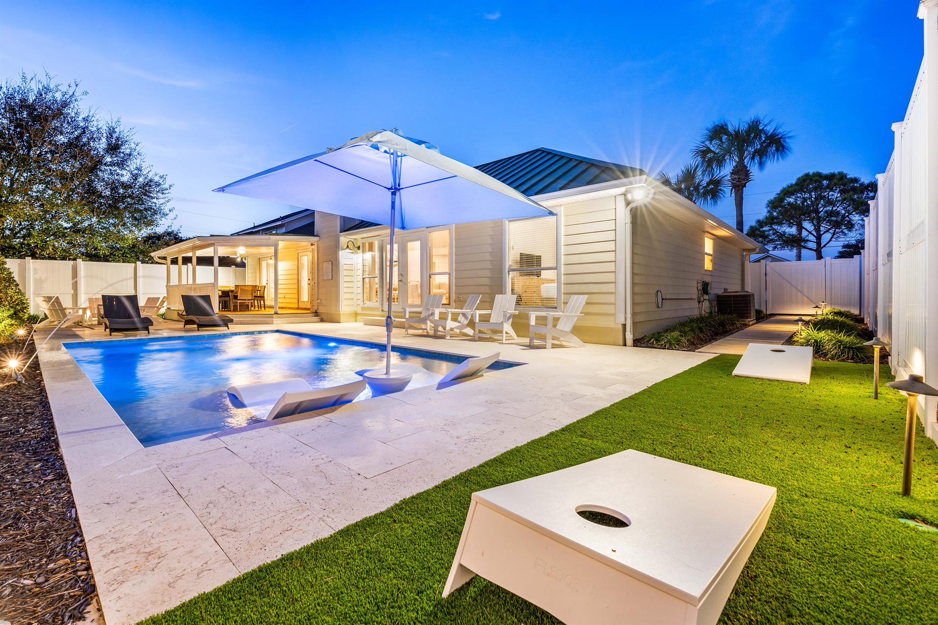 Large Private Pool with Sunshade, in Pool Lounge chairs Spacious Pool Deck with a Fire Pit and covered Dining Area This Backyard is Completely Enclosed, Corn Hole