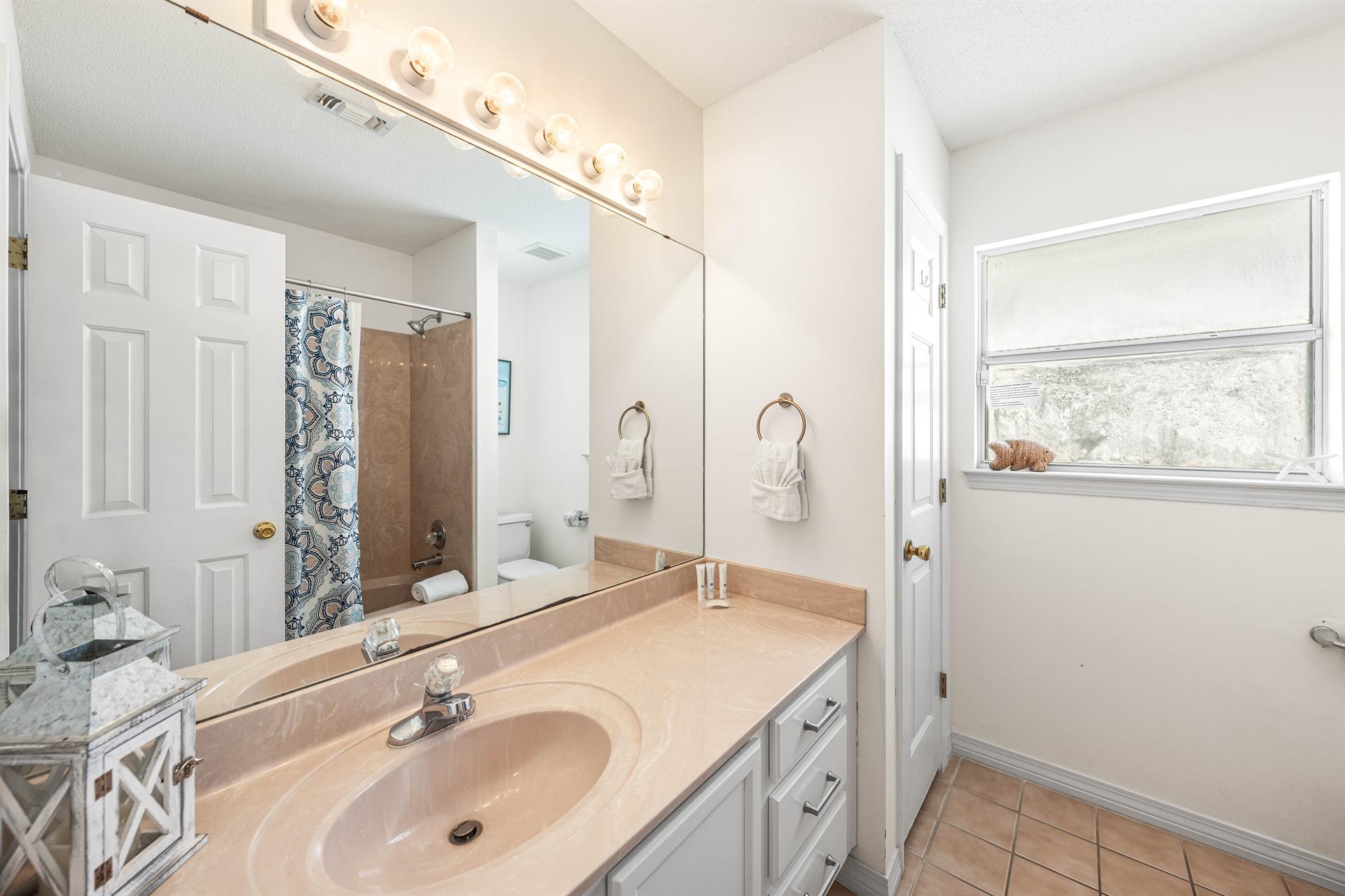 Both the Bunkroom and Guest King Bedroom Share this Single Vanity Bathtub and Shower Combination.