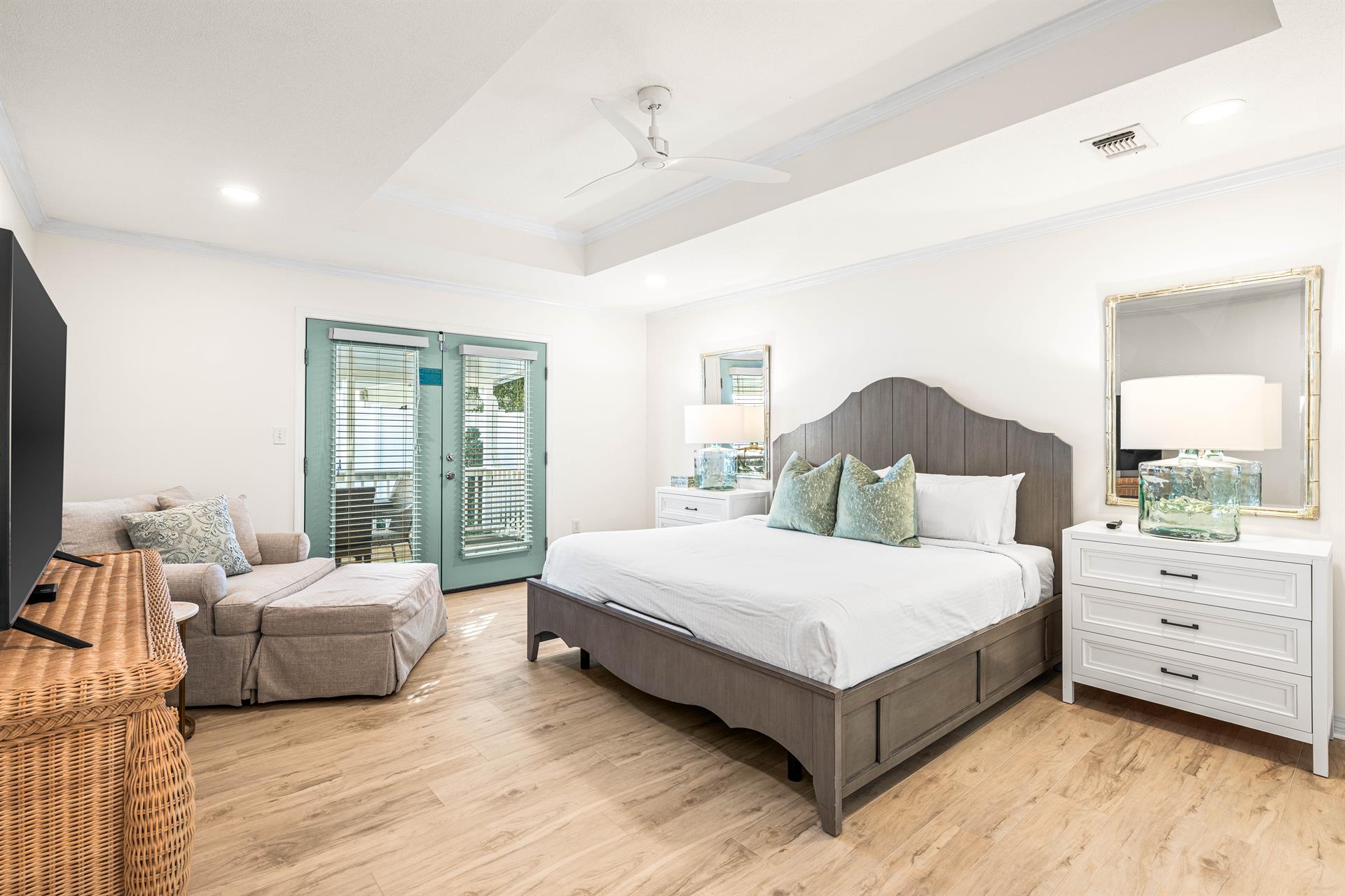 The Primary King Bedroom with Ensuite Soaking Tub, Double Vanity and Walk in Shower, Nightstands, Large Dresser and Comfy Large Chair and Ottoman. 55 Smart TV with Cable.