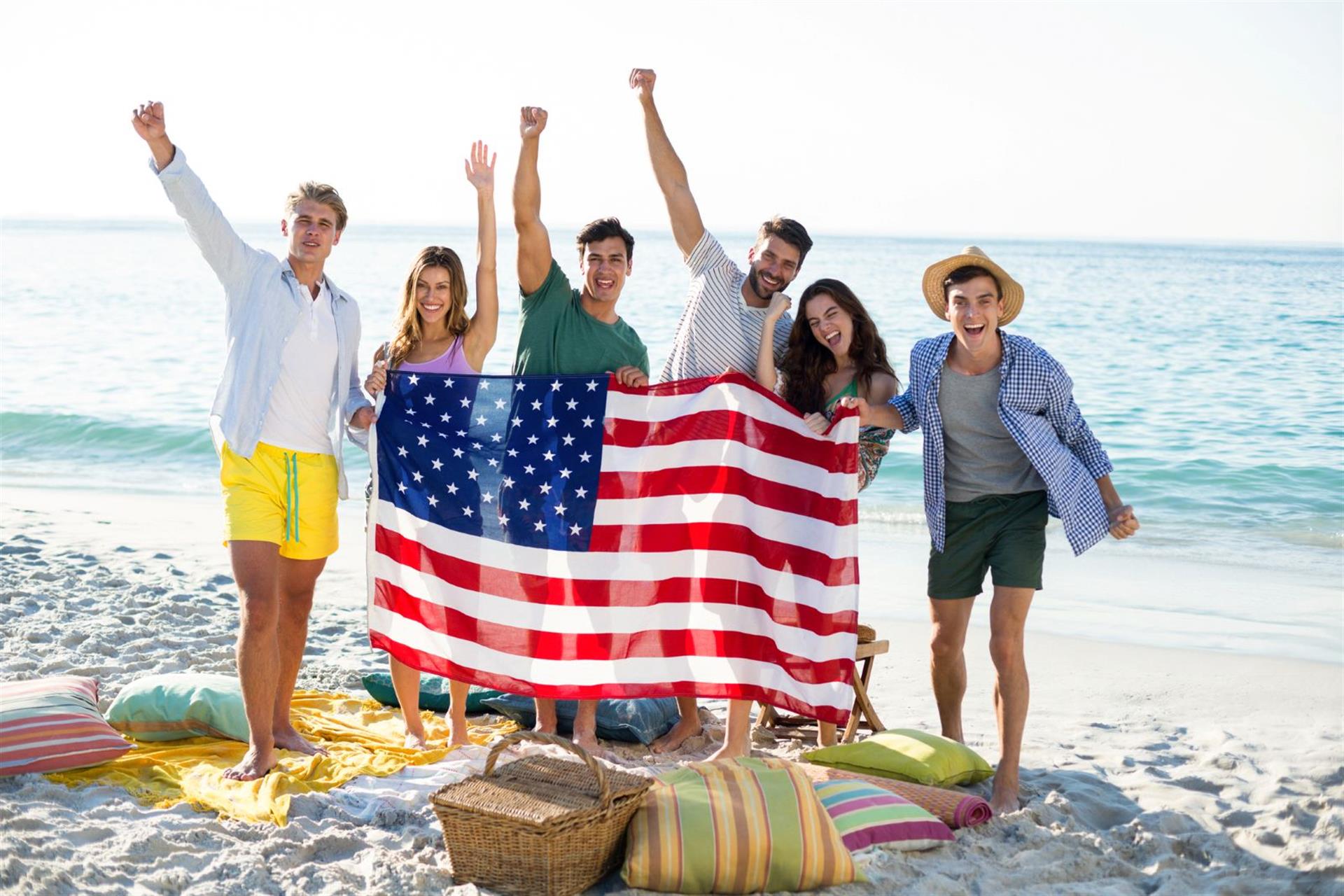 Young people with American Flag on Beach small