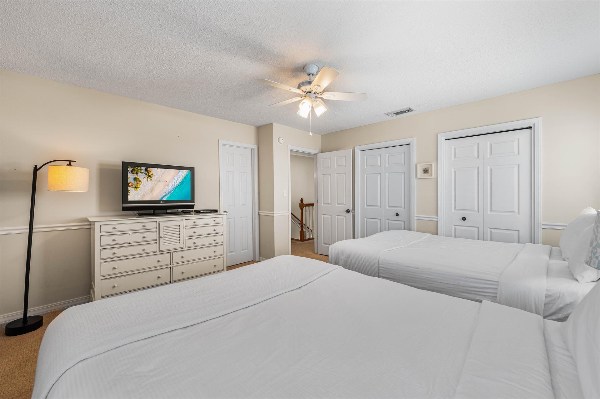 Two queen beds with dresser and 2 closets.