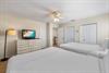 Two queen beds with dresser and 2 closets.