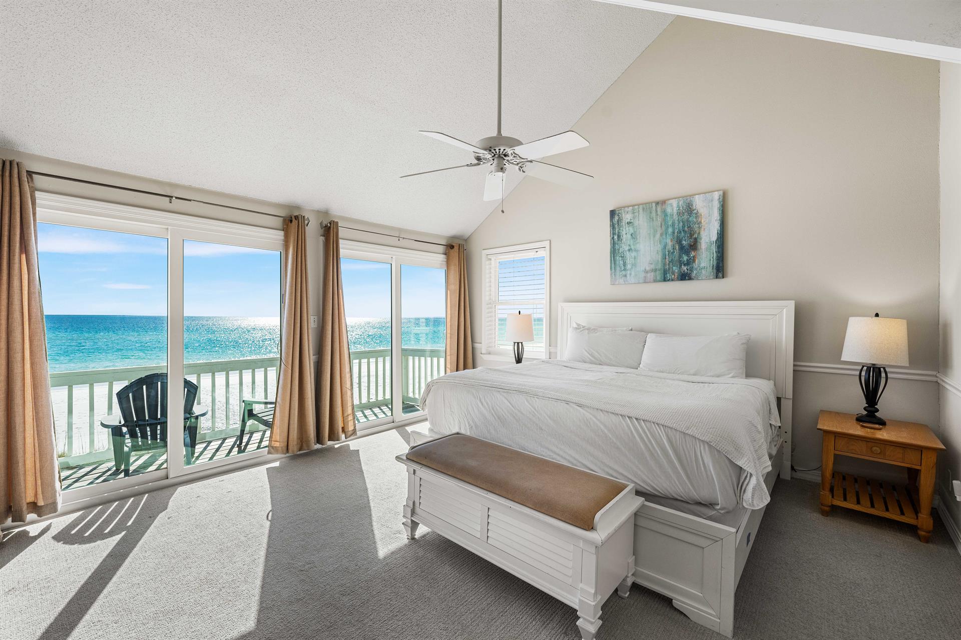 Beachfront primary king bedroom with expansive Gulf views and your private balcony.
