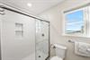 Walkin shower and another view of the coastline from this primary ensuite bathroom.