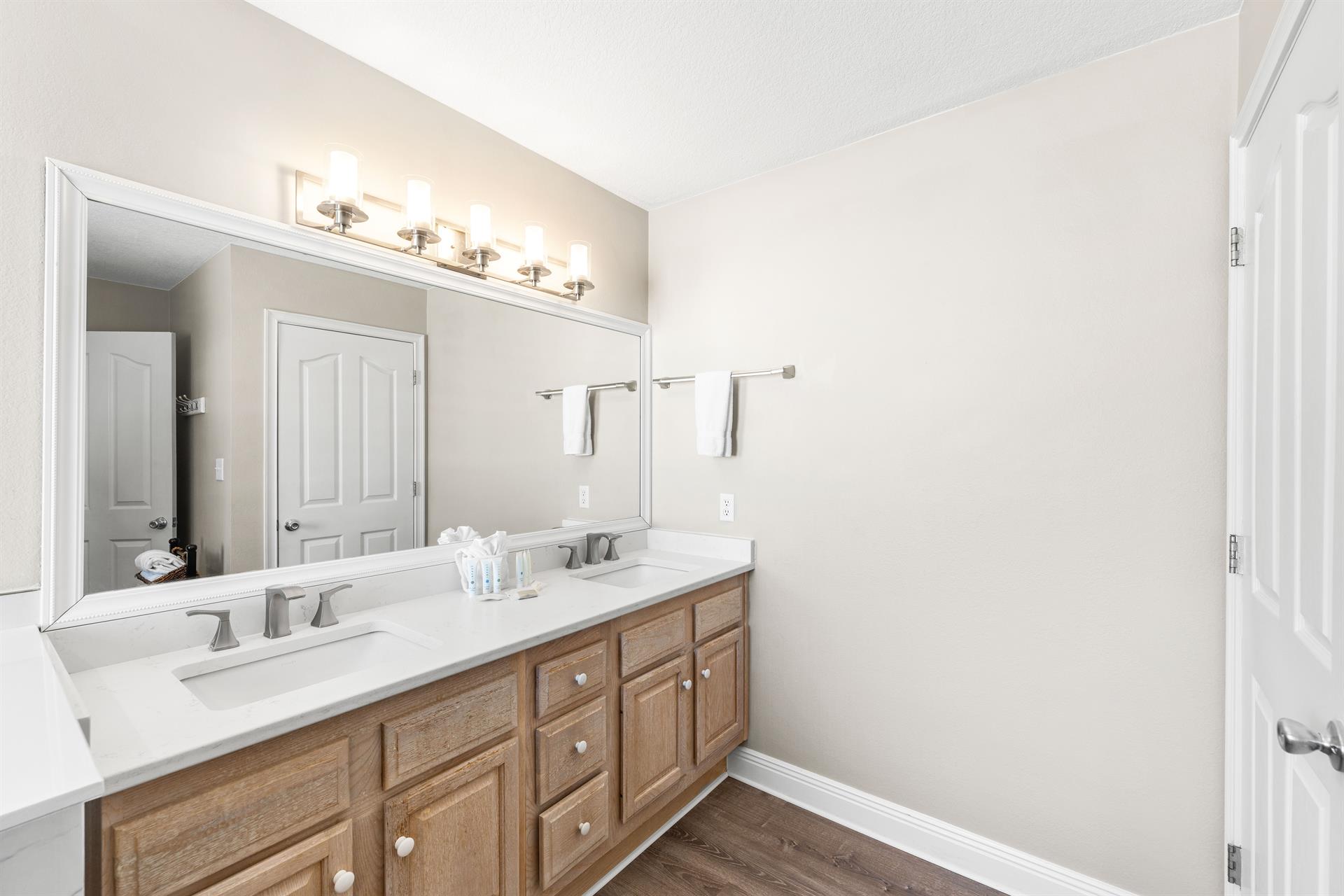 Primary ensuite bathroom with double vanities.