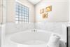 Large soaking tub in this primary ensuite bathroom.