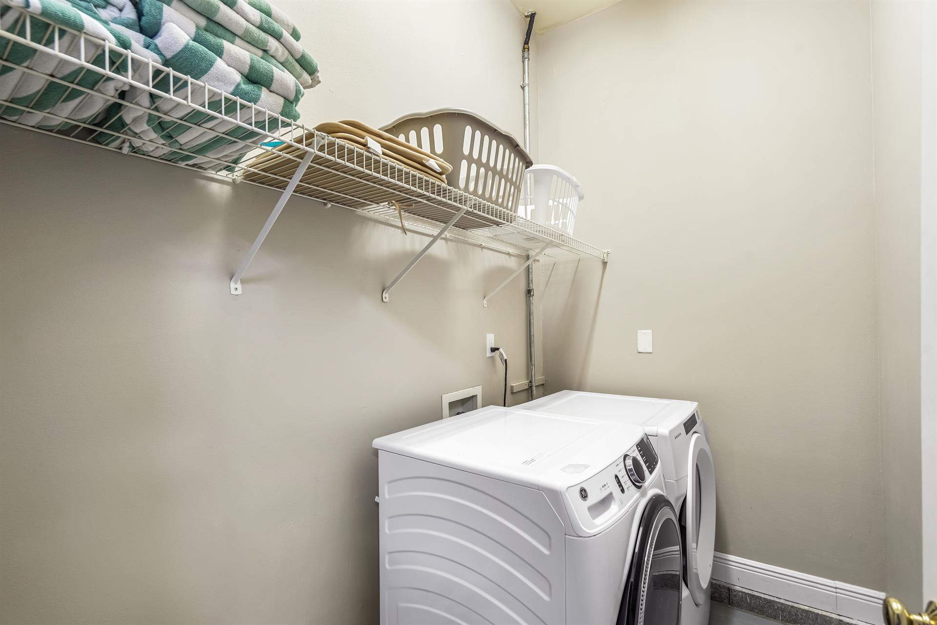 Laundry Room with full size washer and dryer located in separate room off the garage.  Beach Towels are stored here