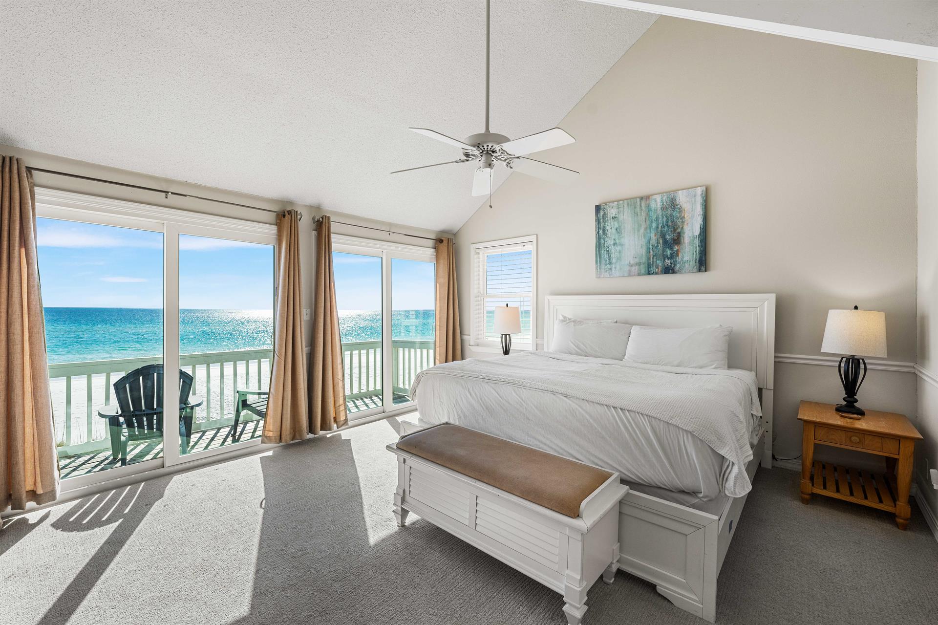 Beachfront primary king bedroom with expansive Gulf views and your private balcony.