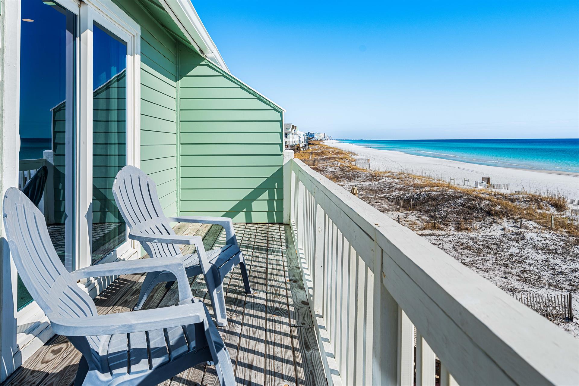 Primary bedroom balcony with views along the coastline.