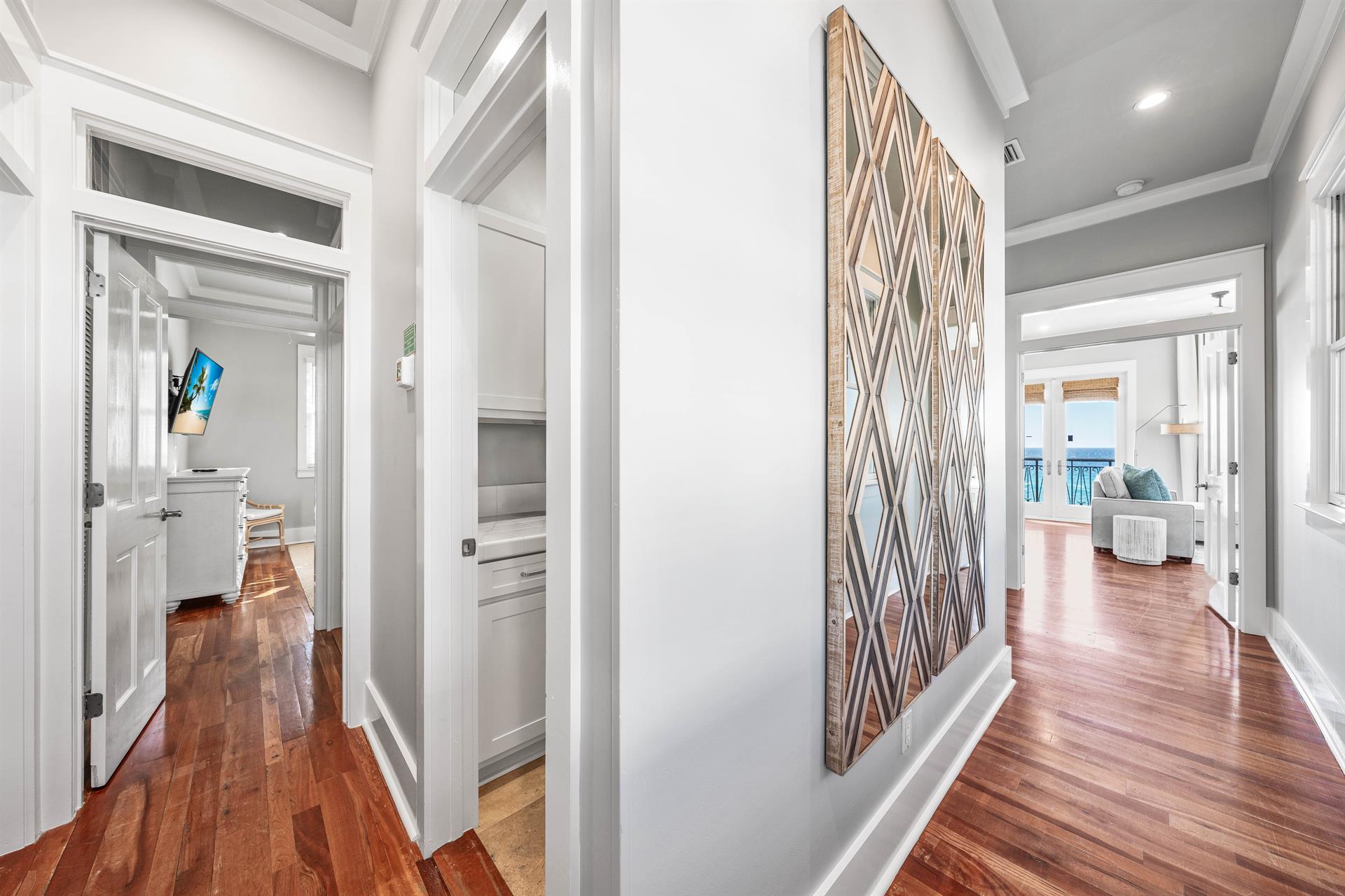 Hallway from Primary Bedroom Leading to 2 bedrooms and laundry room