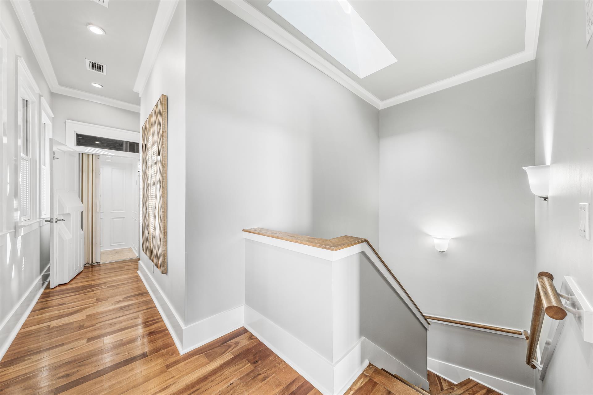 Elevator and Stairs going down the Second and First Floors.