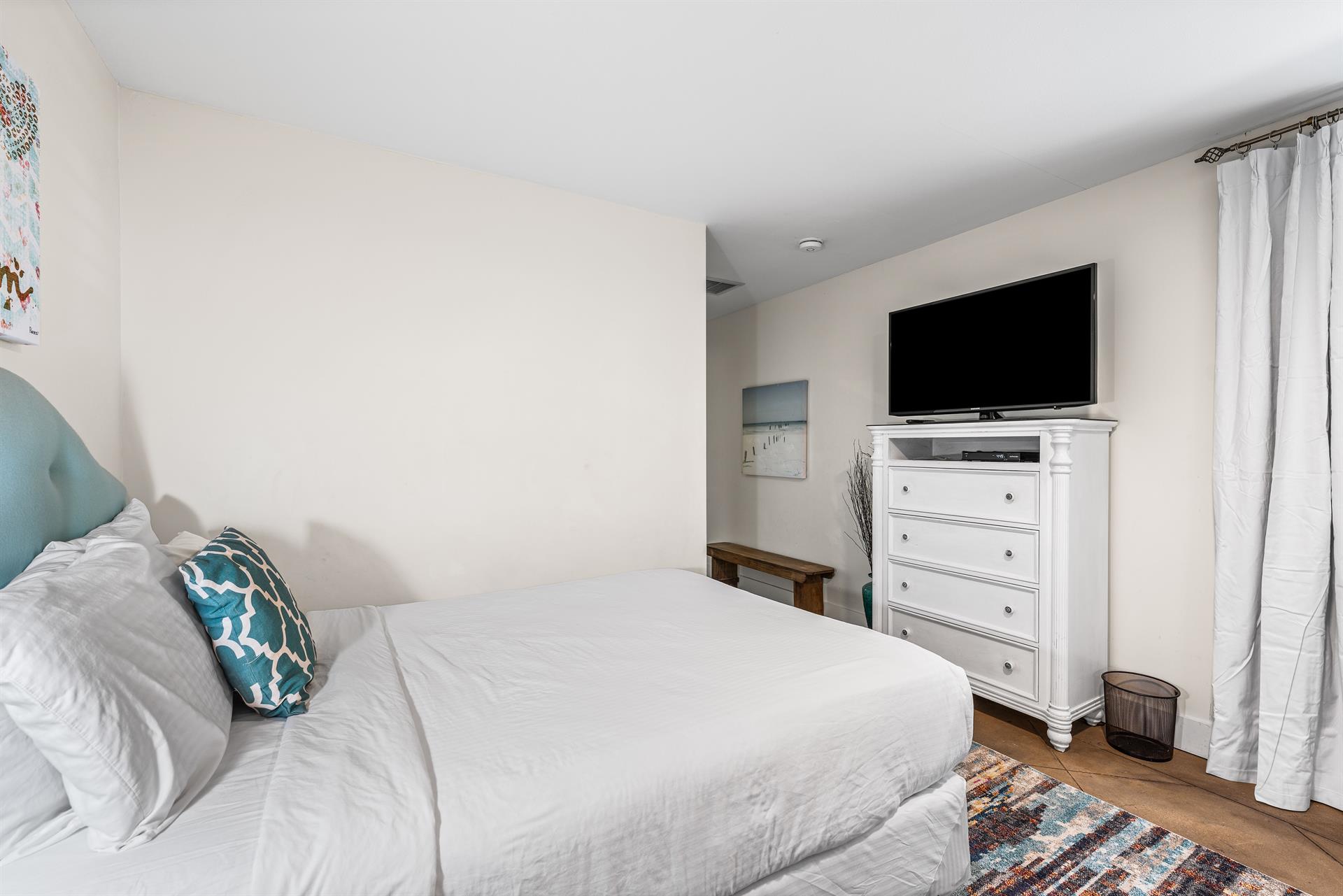 East end of Seabreeze has a 2nd bedroom with 2 queen beds  adjacent full bathroom with a walkin shower.   TV located above the chest of drawers