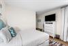 East end of Seabreeze has a 2nd bedroom with 2 queen beds  adjacent full bathroom with a walkin shower.   TV located above the chest of drawers