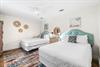 East end of Seabreeze has a 2nd bedroom with 2 queen beds  adjacent full bathroom with a walkin shower.   TV located above the chest of drawers