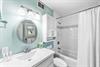 Primary bedrooms ensuite bathroom with a bathtubshower combination.