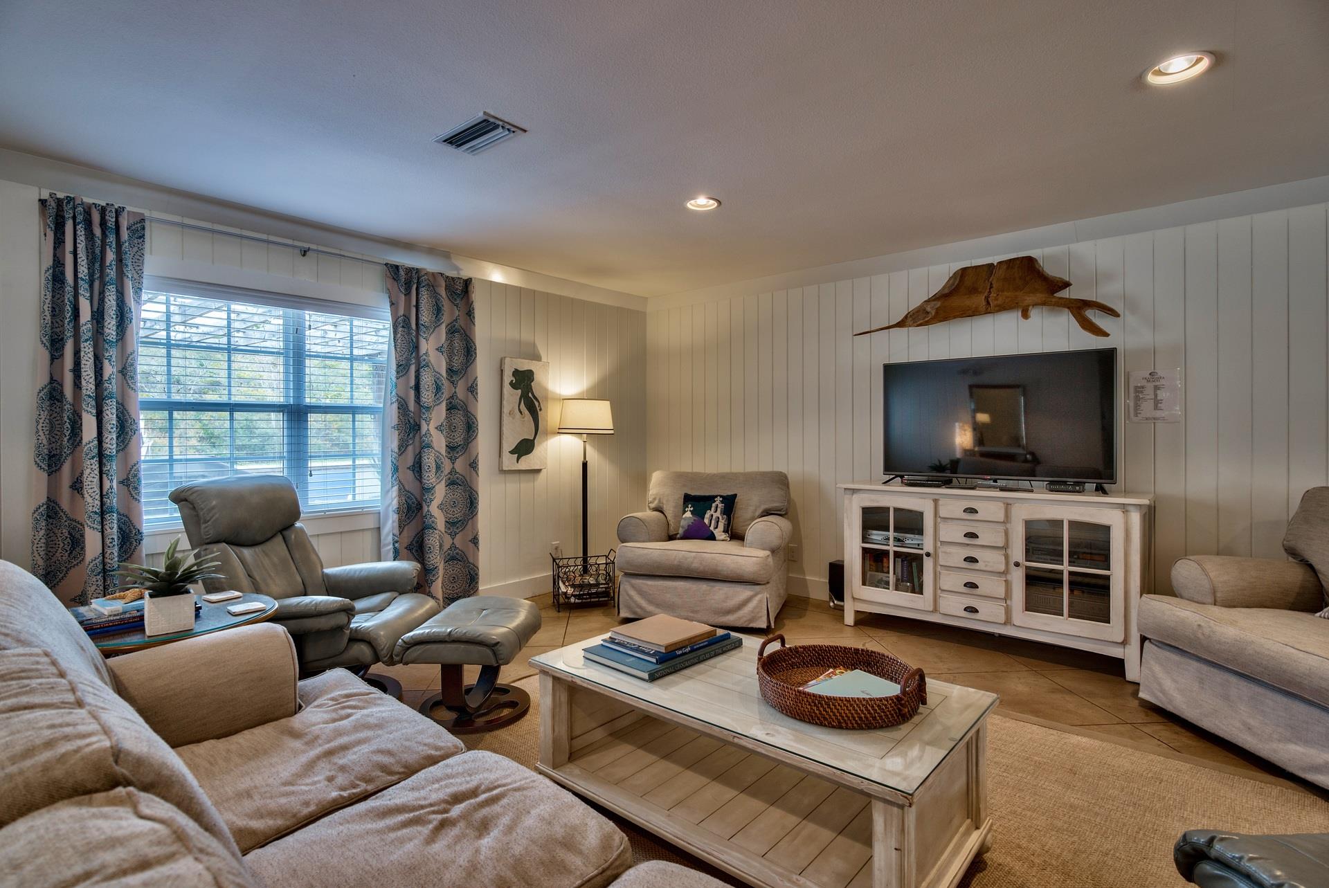 Open Concept Living Area With Sleeper Sofa, 50 TV, Plenty of Space for Family Gatherings, and a Pac Man Game Arcade.