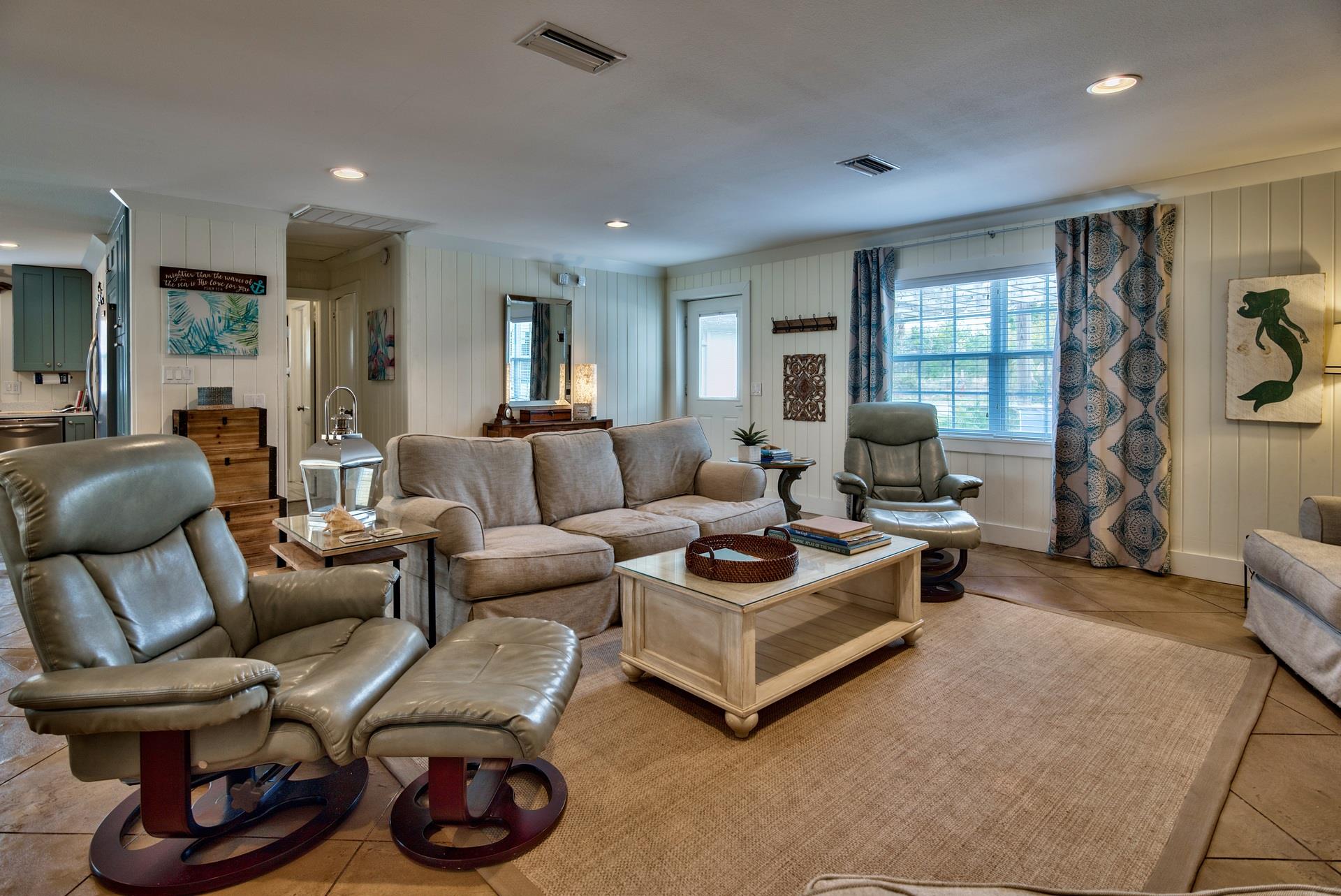 Open Concept Living Area With Sleeper Sofa, 50 TV, Plenty of Space for Family Gatherings, and a Pac Man Game Arcade.