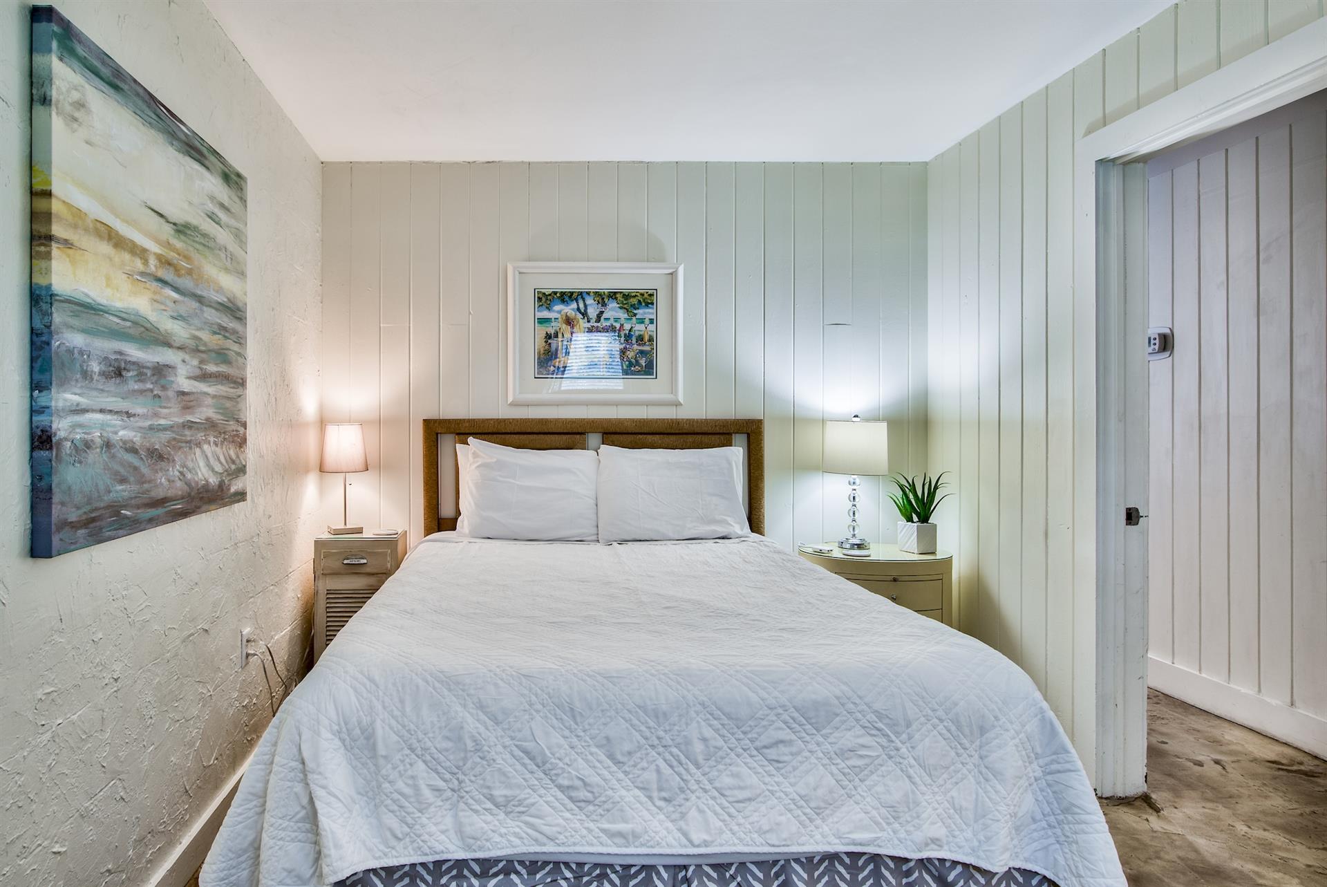 First bedroom on the west end of Seabreeze with Queen bed, walkin closet,  adjacent full bathroom with walkin shower.