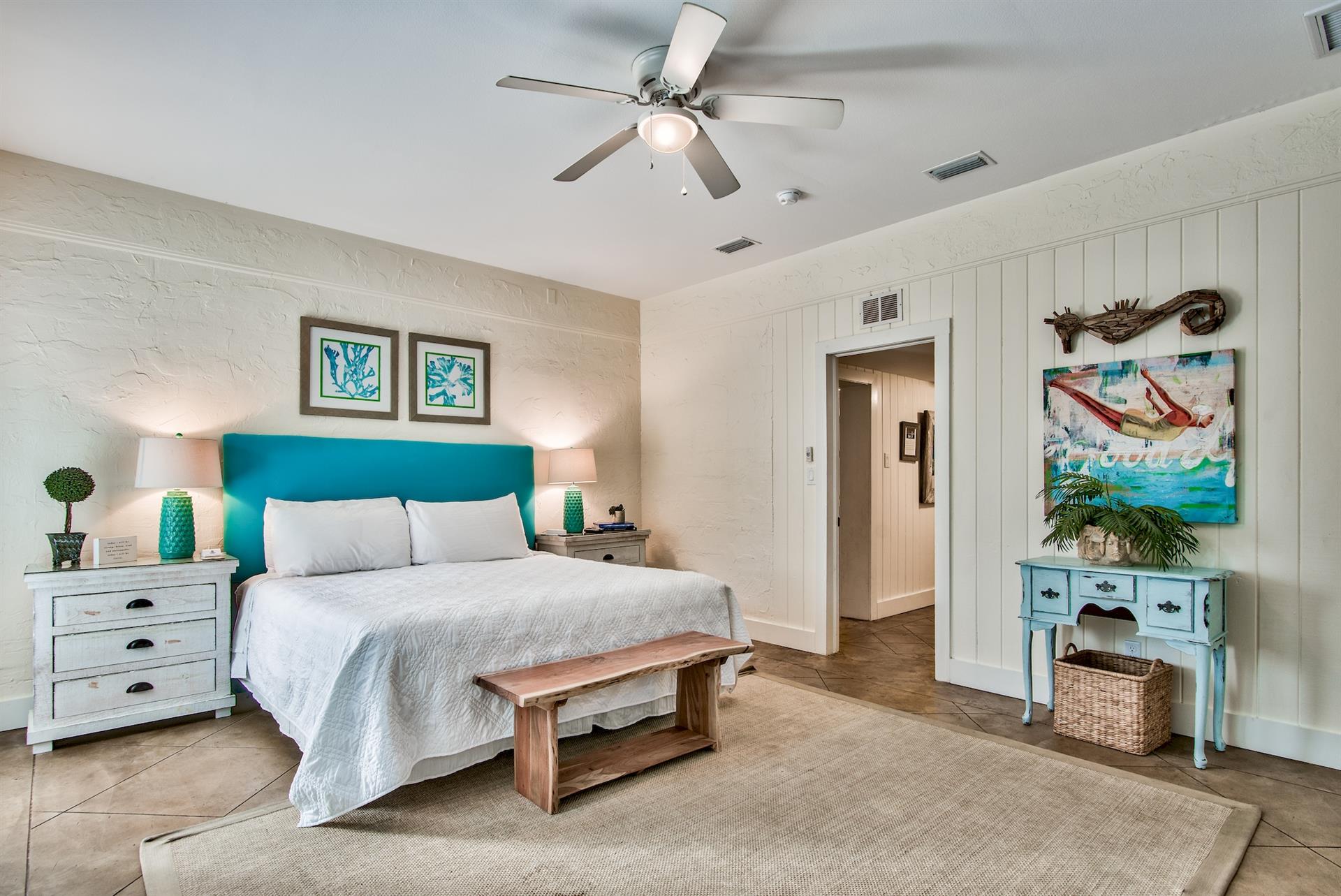 3rd Bedroom is the primary suite on the east end with a king bed, 45 TV,  walkin closet, ensuite full bathroom with a bathtubshower combination, and views of the pool area  door leading out to the pool.  safety alarm on door