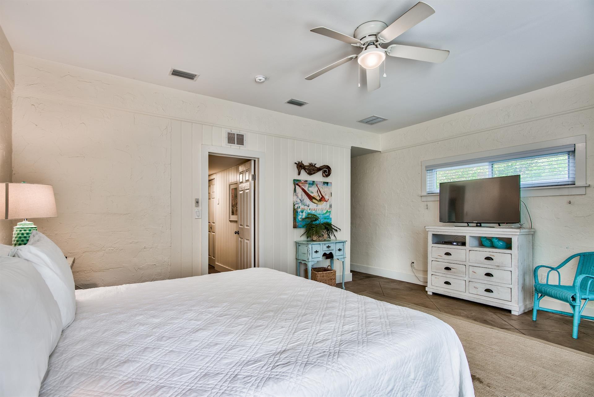 3rd Bedroom is the primary suite on the east end with a king bed, 45 TV,  walkin closet, ensuite full bathroom with a bathtubshower combination, and views of the pool area  door leading out to the pool.  safety alarm on door
