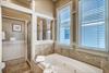 Primary ensuite bathroom with soaking bathtub  separate walkin shower