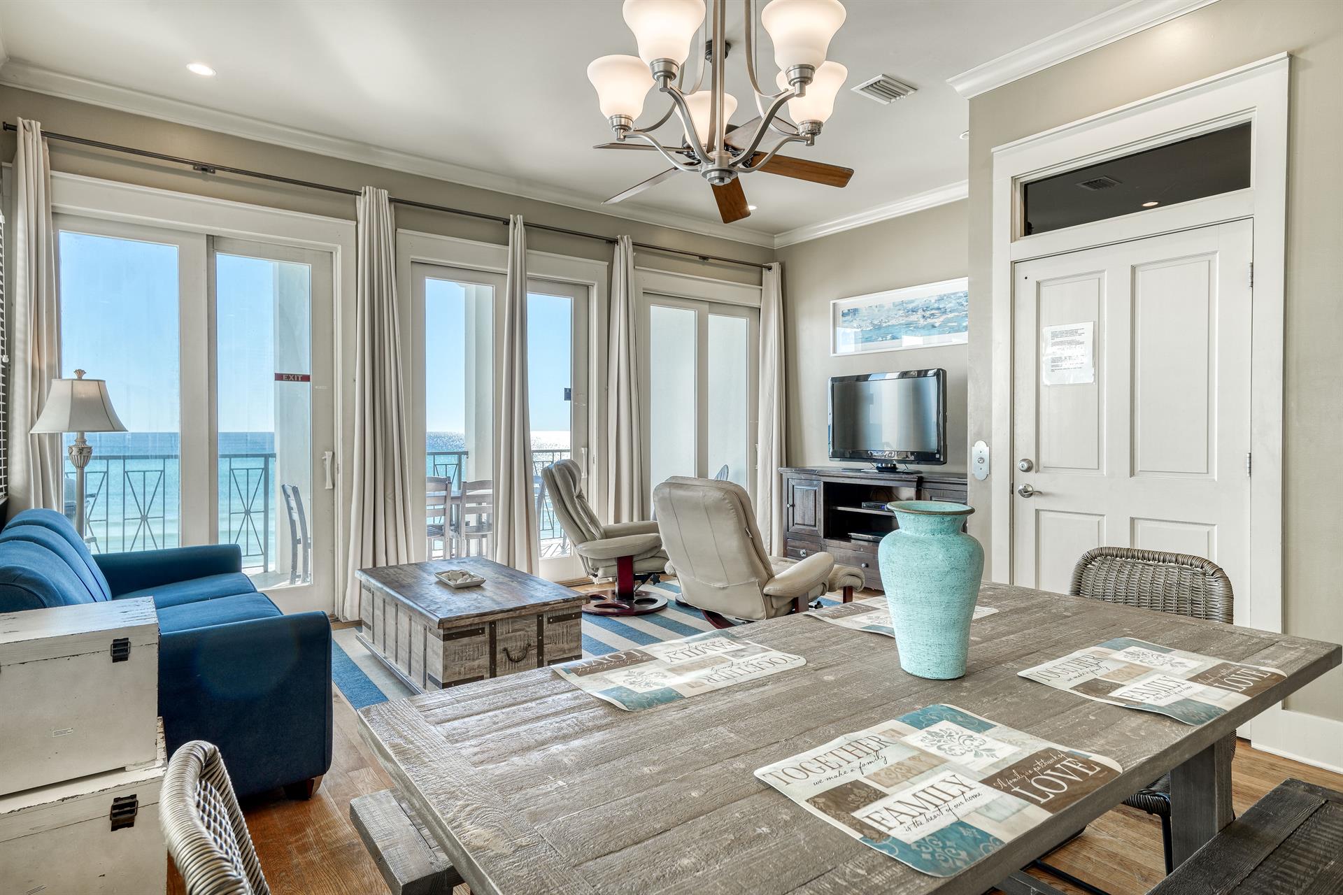 2nd floor living area that opens up to the private covered balcony.   Comfortable furnishings and picnic style dining table.