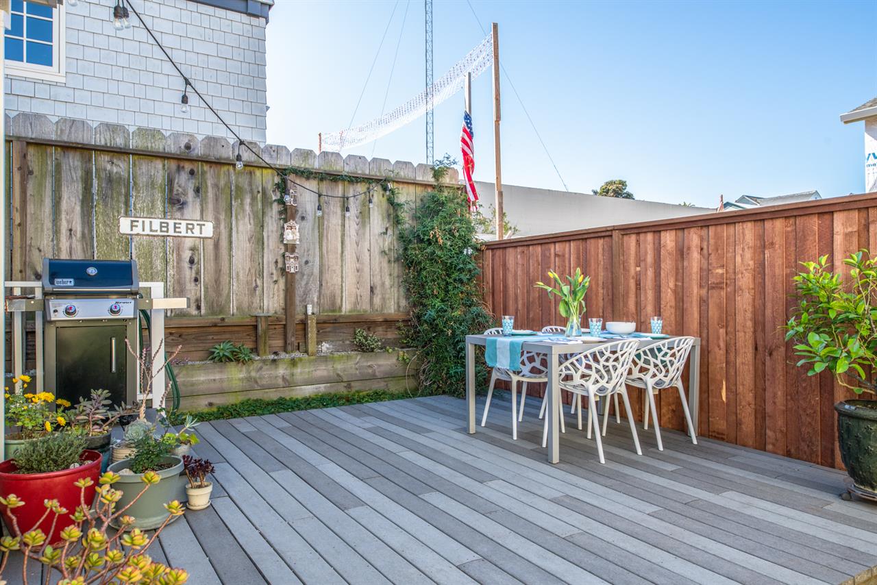 Backyard has a Gas Grill and Dining Area
