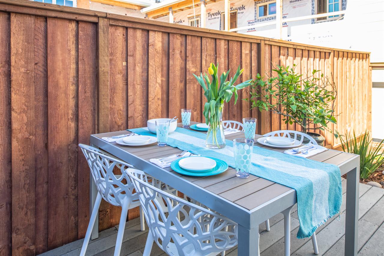 Backyard has a Gas Grill and Dining Area
