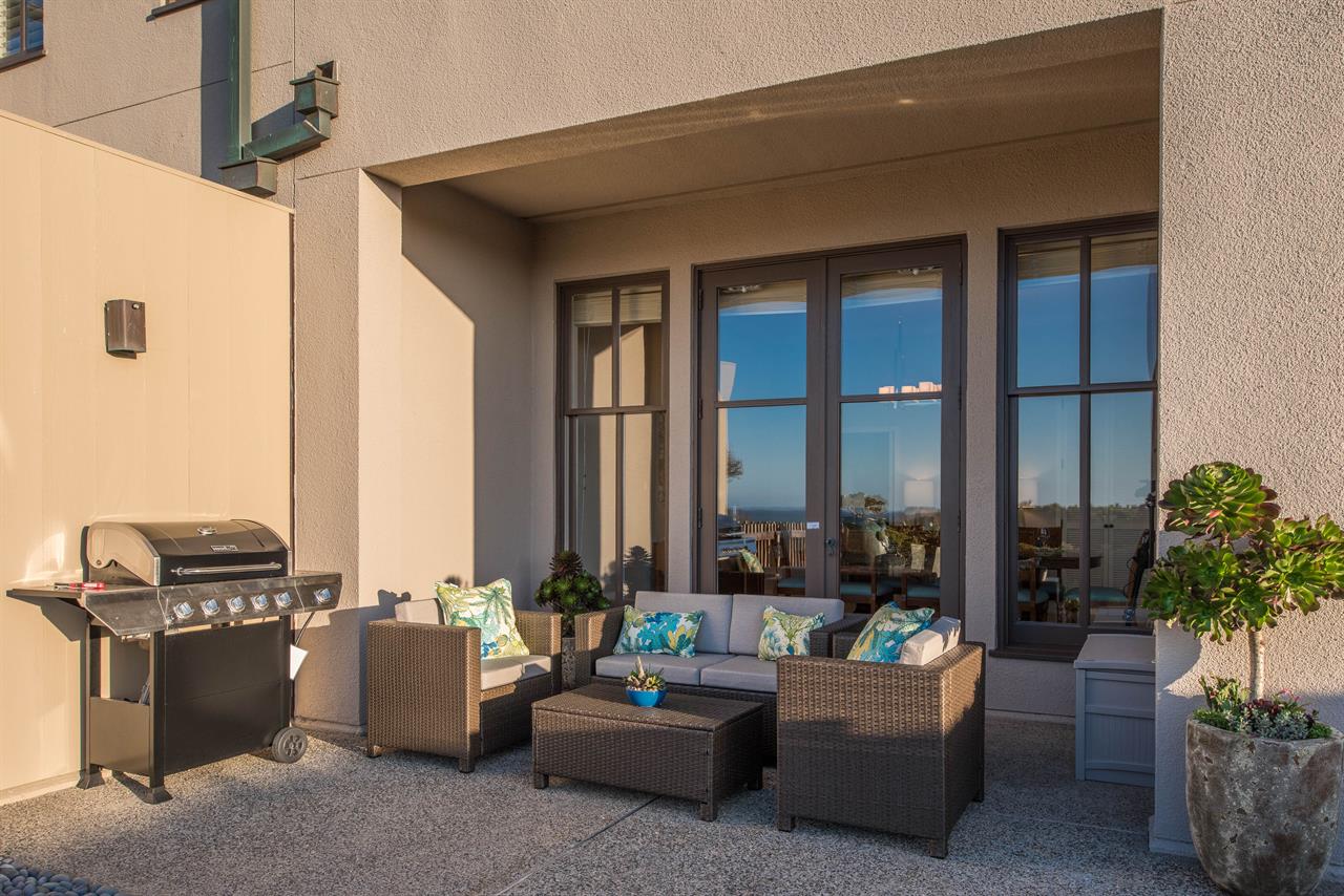 Backyard Lounging Area with a Gas Grill and Ocean View