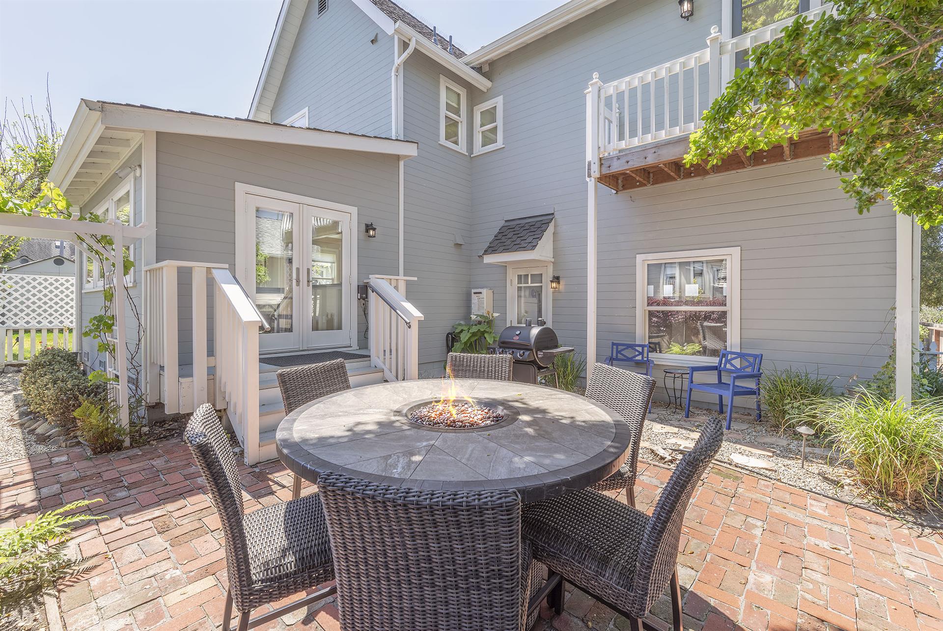Backyard with a Fire Pit Table and Gas BBQ