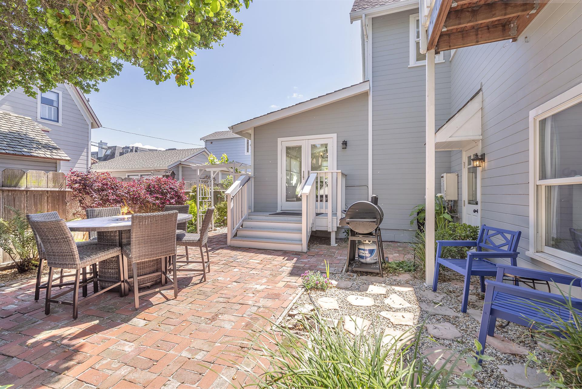 Backyard with a Fire Pit Table and Gas BBQ