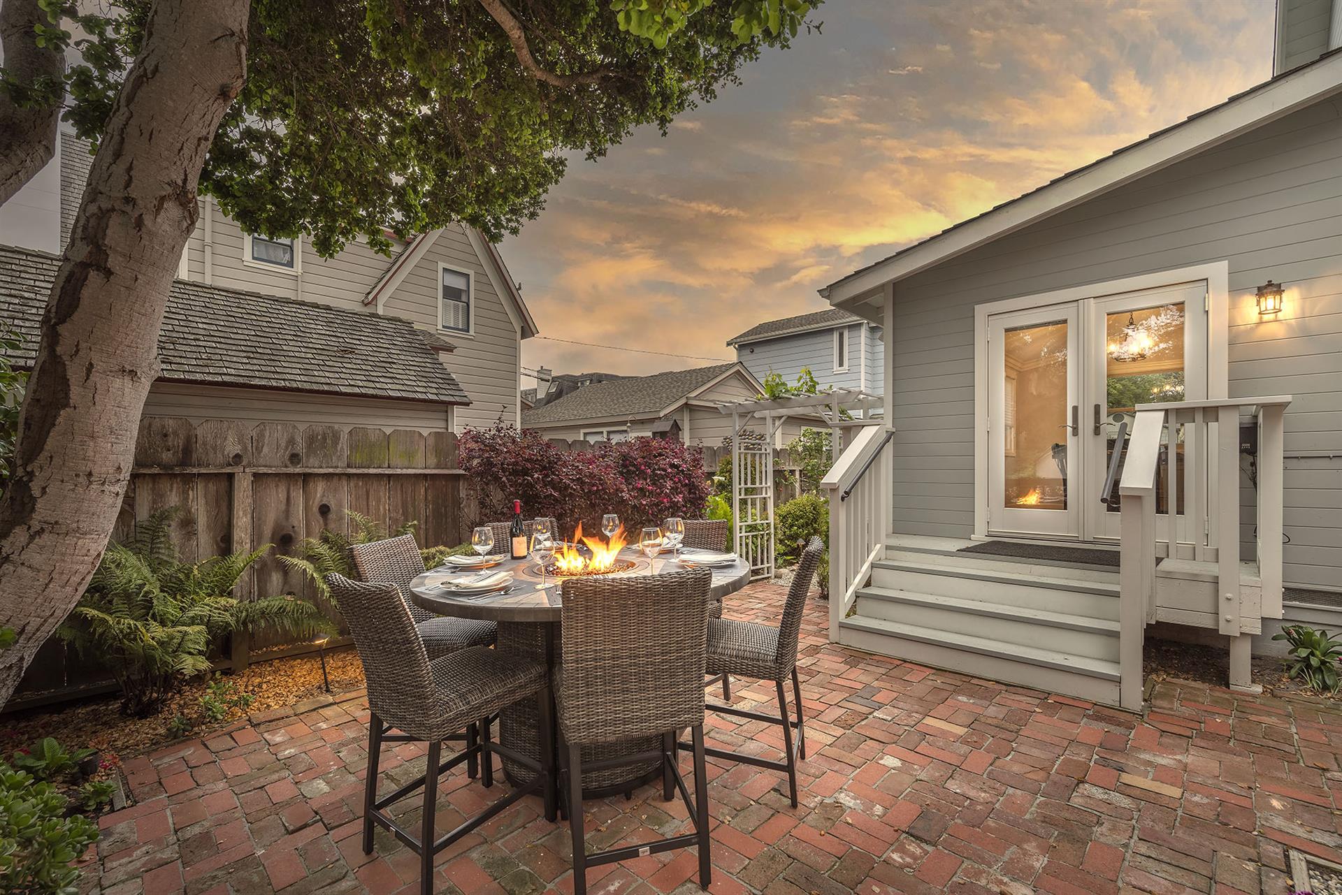 Backyard at Dusk with a Fire Pit Table and Gas BBQ