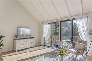 Living Room with HDTV, Balcony and Vaulted Ceiling