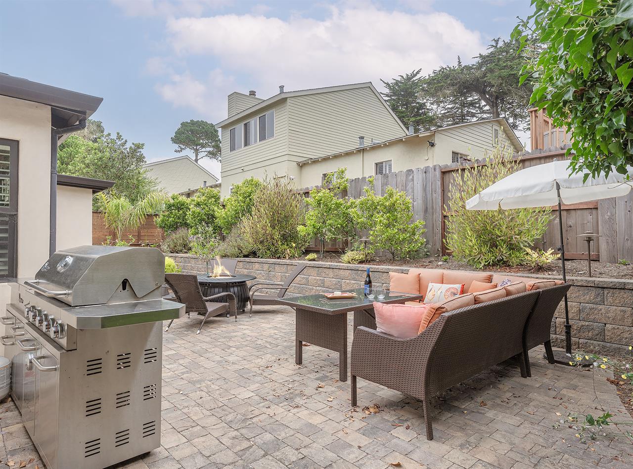 Backyard has a Gas Grill, Dining Area and a Fire Pit
