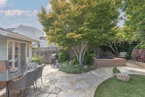 Backyard with Gas BBQ Grill Dining Area and a Hot Tub