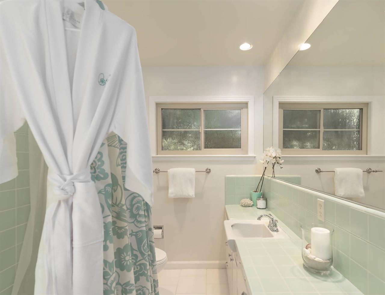 Hall Bath has a Shower Over Tub in Soothing Colors of the Sea