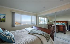 Bedroom 1 has a Plush Queen Bed and Bay View